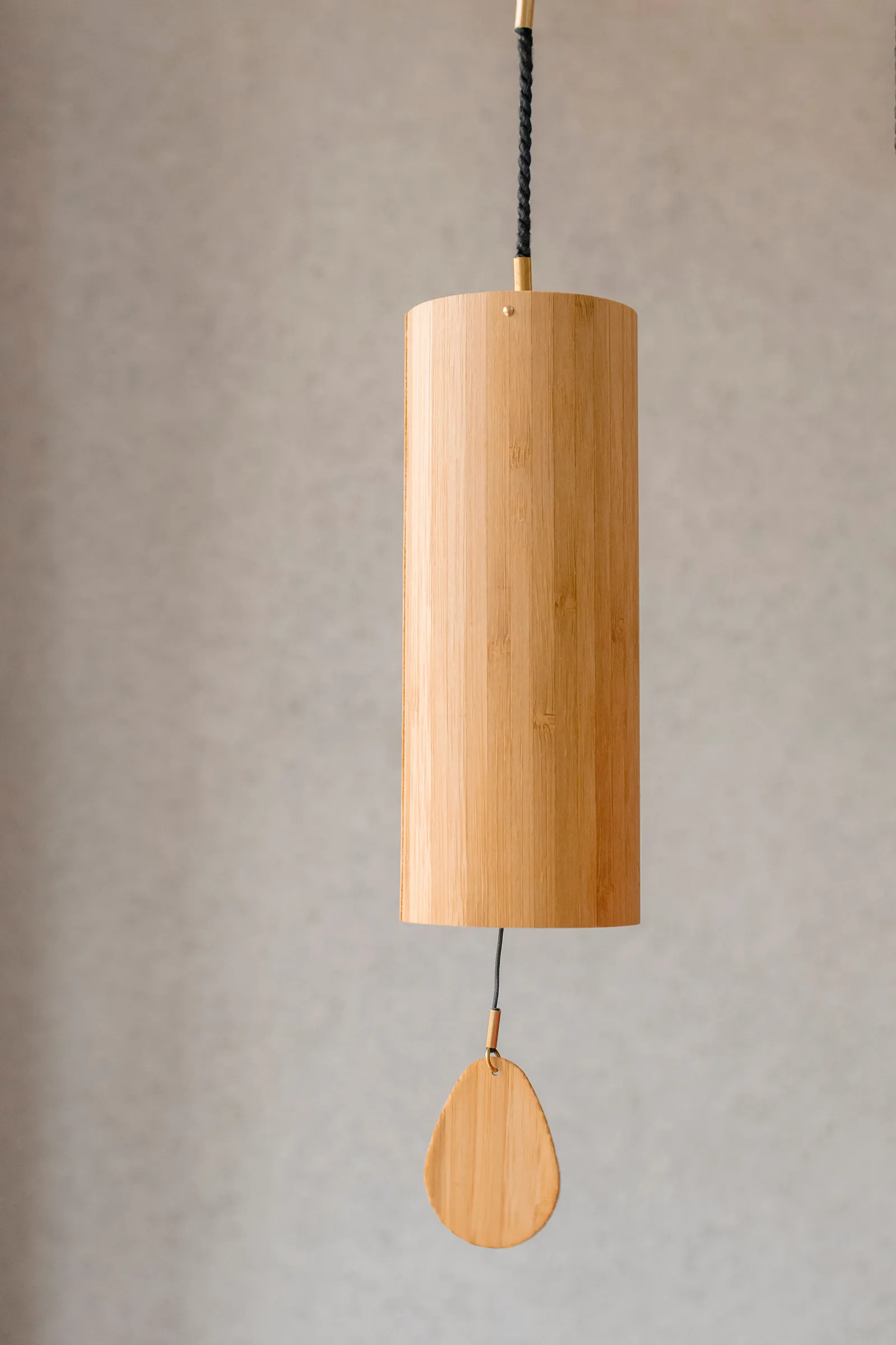 A wooden wind chime hangs from the ceiling.